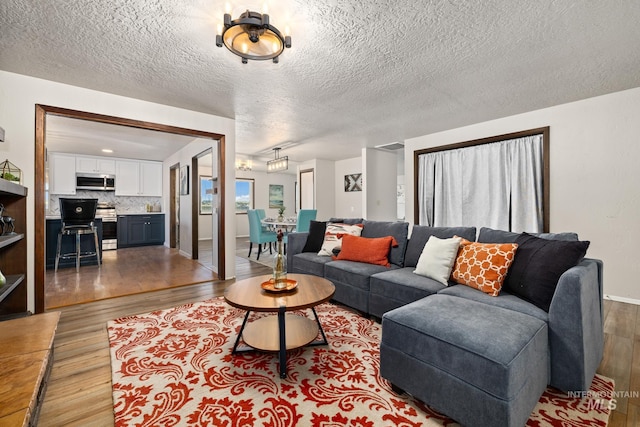 living room featuring a textured ceiling and light wood-type flooring