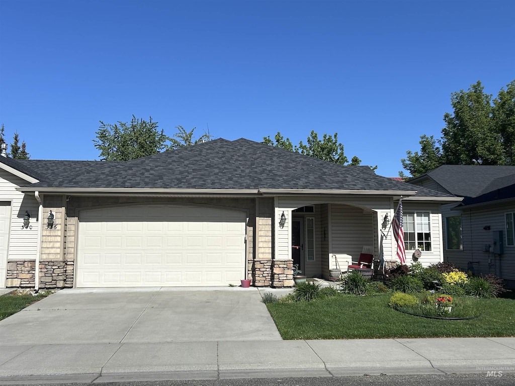 336 S Golden Eagle Ln, Eagle, ID 83616 - ranch-style home featuring concrete driveway, a porch, a garage, and stone siding
