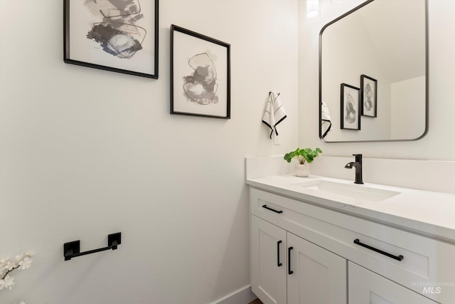 bathroom featuring vanity and baseboards