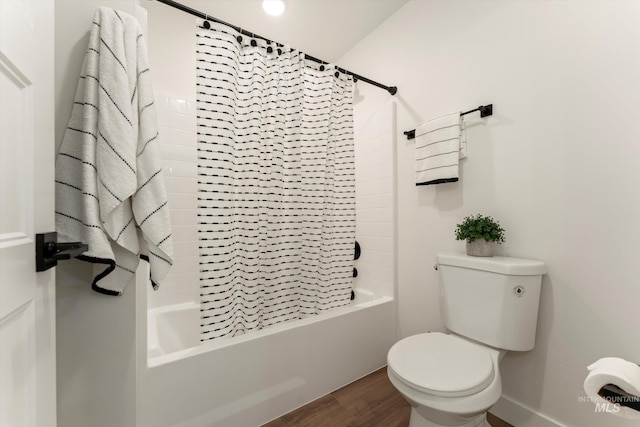 full bathroom featuring shower / bath combo, wood finished floors, toilet, and baseboards