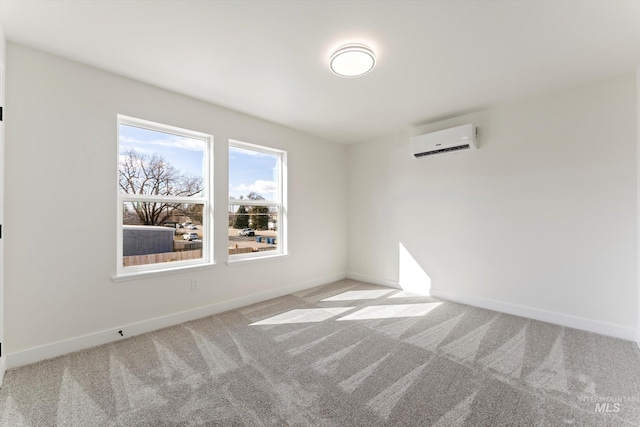 spare room featuring baseboards, light colored carpet, and a wall mounted air conditioner