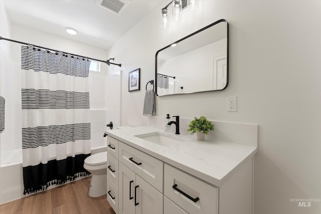 full bathroom with toilet, visible vents, shower / bath combination with curtain, and vanity