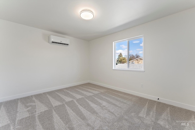 empty room with a wall mounted air conditioner, light carpet, and baseboards