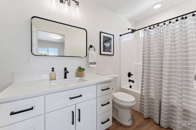 full bathroom with toilet, shower / tub combo with curtain, wood finished floors, and vanity