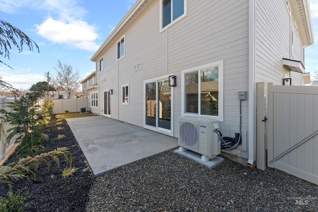 back of house featuring ac unit, a fenced backyard, a patio, and central AC