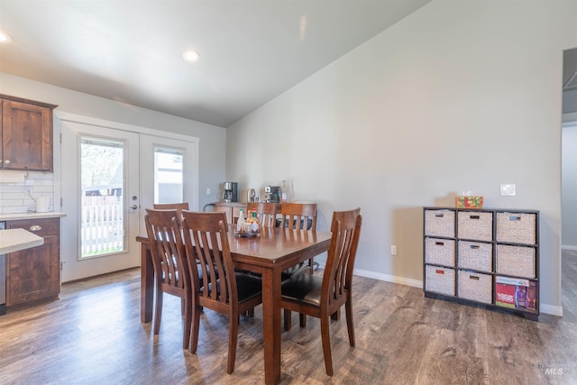 dining area featuring baseboards, wood finished floors, and french doors