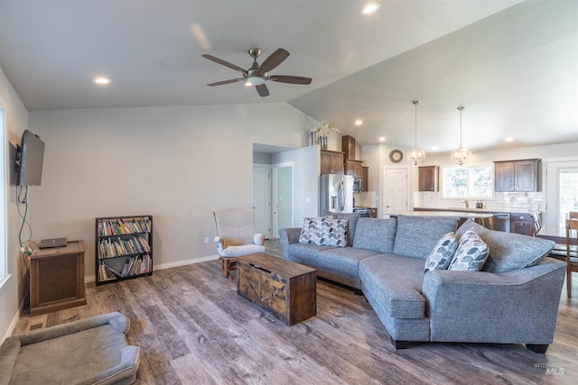 living room with dark wood-type flooring, recessed lighting, ceiling fan, and lofted ceiling