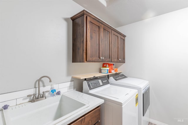 laundry room featuring a sink, cabinet space, and washing machine and dryer