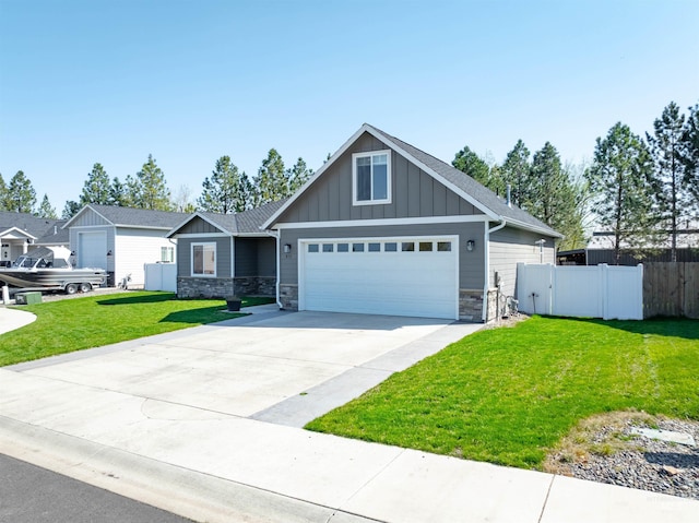 craftsman-style home with fence, stone siding, a garage, board and batten siding, and driveway