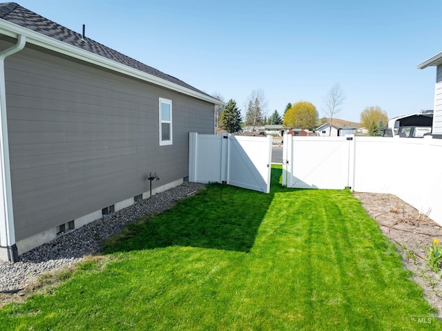 view of yard featuring fence and a gate