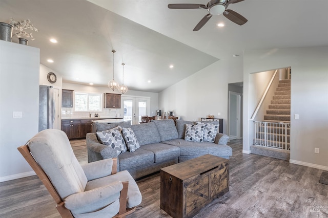 living room with stairs, recessed lighting, vaulted ceiling, and wood finished floors