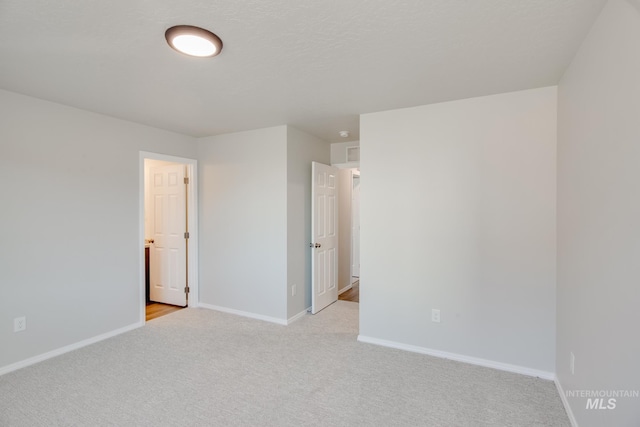 empty room with light colored carpet