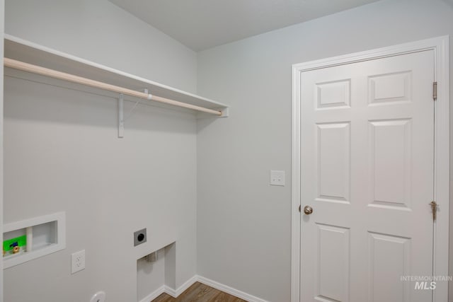 clothes washing area with electric dryer hookup, hookup for a washing machine, and wood-type flooring