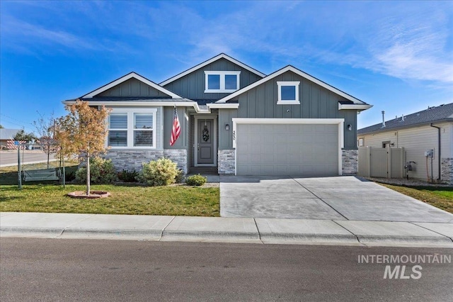 300 S Adventure Way, Kuna, ID 83634 - craftsman-style home featuring stone siding, concrete driveway, and board and batten siding