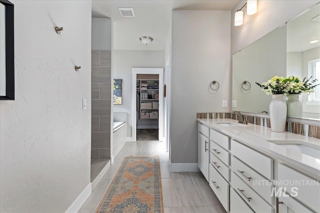 300 S Adventure Way, Kuna, ID 83634 - bathroom with double vanity, baseboards, a walk in closet, a shower, and a bathtub