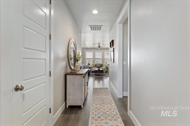 300 S Adventure Way, Kuna, ID 83634 - hall featuring a textured ceiling, baseboards, and wood finished floors