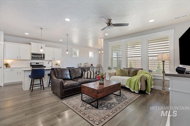 300 S Adventure Way, Kuna, ID 83634 - living area with ceiling fan, recessed lighting, wood finished floors, and a textured ceiling