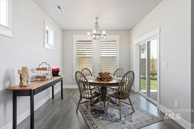 300 S Adventure Way, Kuna, ID 83634 - dining space featuring healthy amount of natural light, a chandelier, dark wood finished floors, and baseboards
