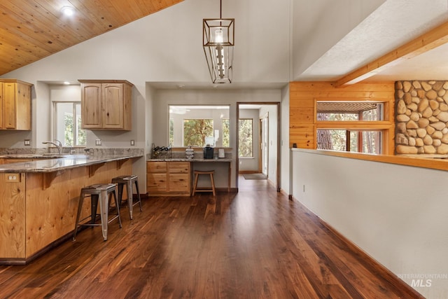 16 Meadow Ln, Boise, ID 83716 - kitchen featuring a kitchen bar, dark wood-style floors, light brown cabinetry, stone countertops, and recessed lighting