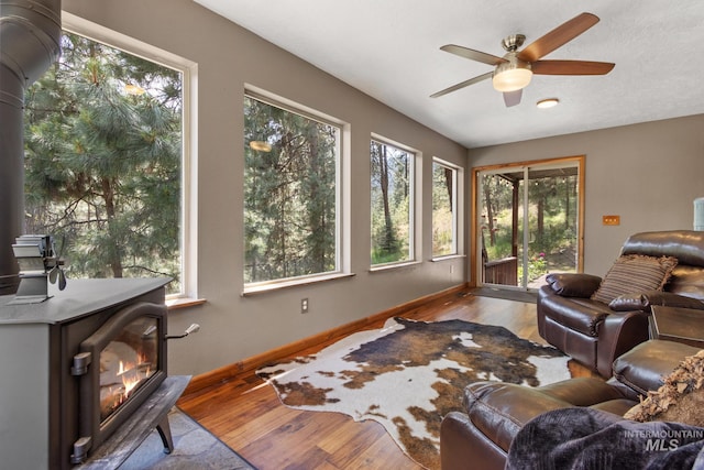 16 Meadow Ln, Boise, ID 83716 - living area featuring a ceiling fan, wood finished floors, and a wood stove