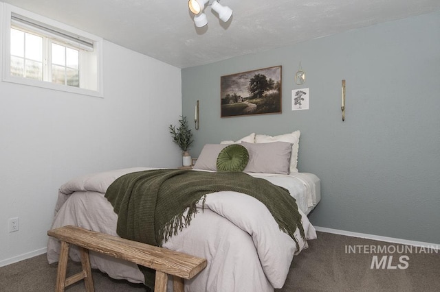 carpeted bedroom with baseboards and ceiling fan