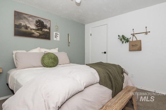 carpeted bedroom with baseboards