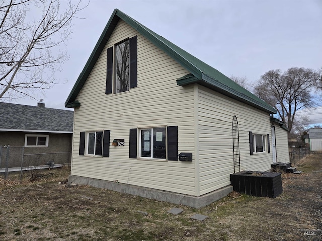 view of side of property featuring fence