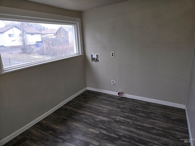 spare room featuring baseboards and dark wood-style flooring