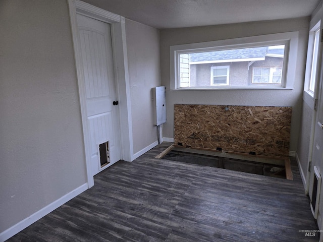 bathroom with wood finished floors and baseboards