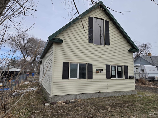 rear view of property featuring fence