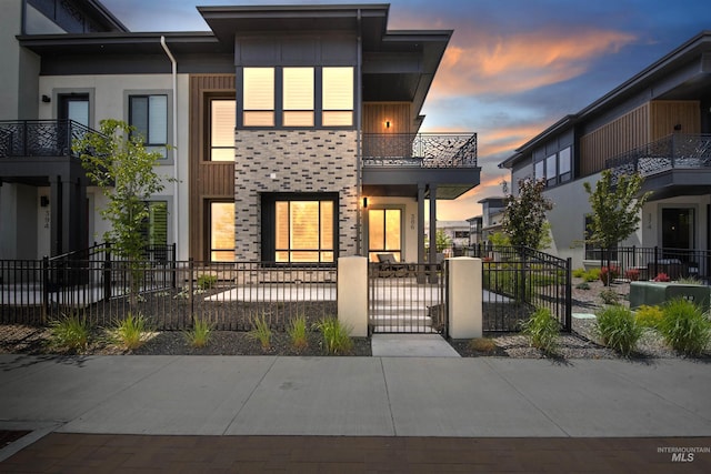 386 E Presidio Ln, Eagle, ID 83616 - view of front of house with a balcony, a fenced front yard, a gate, and stucco siding
