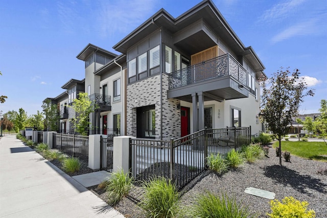 386 E Presidio Ln, Eagle, ID 83616 - view of side of property featuring a balcony, a fenced front yard, stucco siding, and a gate