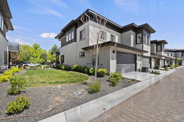 386 E Presidio Ln, Eagle, ID 83616 - view of property exterior with a garage, stucco siding, driveway, a lawn, and central AC unit