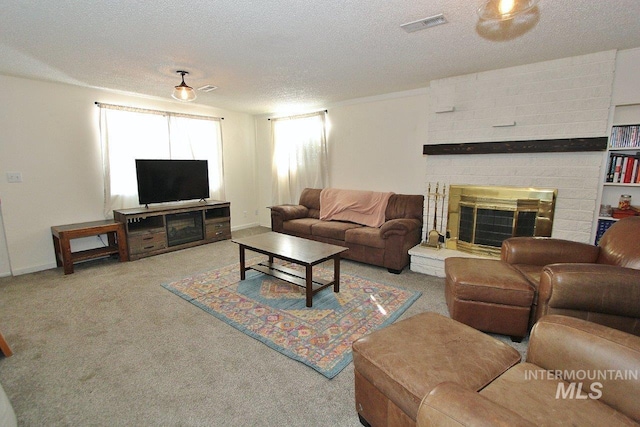 living room featuring a textured ceiling, light colored carpet, and a fireplace