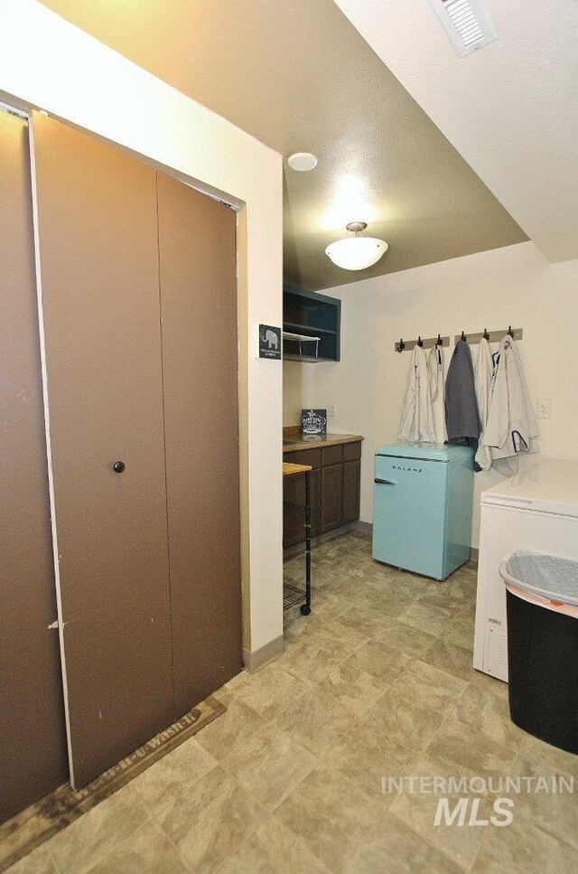 bedroom featuring refrigerator and a closet