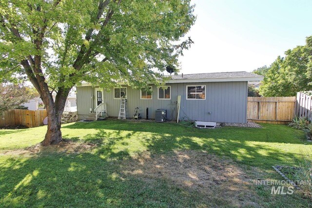 rear view of house with a lawn