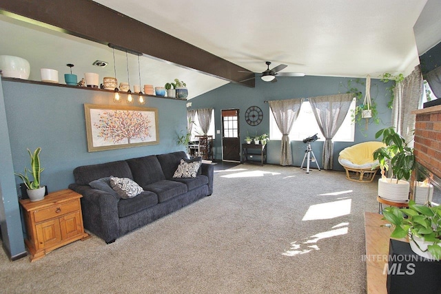 living room with carpet, lofted ceiling with beams, ceiling fan, and a brick fireplace