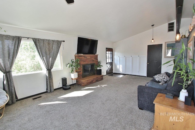 living room with a fireplace, carpet flooring, and lofted ceiling