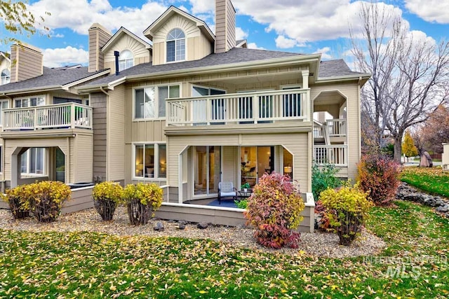 rear view of house featuring a balcony