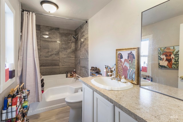 full bathroom featuring toilet, shower / tub combo with curtain, vanity, and hardwood / wood-style flooring