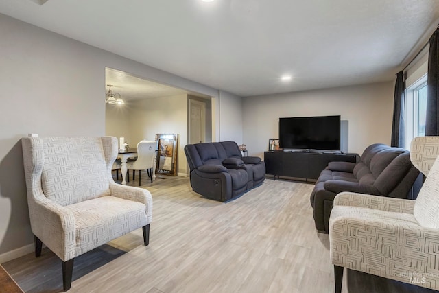 living room featuring hardwood / wood-style flooring and a notable chandelier