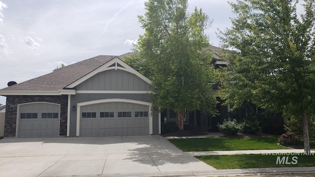 2527 E Taormina Dr, Meridian, ID 83642 - view of front facade with an attached garage, driveway, roof with shingles, and stone siding