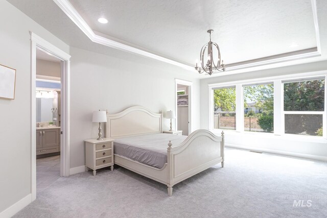 2527 E Taormina Dr, Meridian, ID 83642 - bedroom with carpet flooring, a tray ceiling, a chandelier, ensuite bath, and baseboards