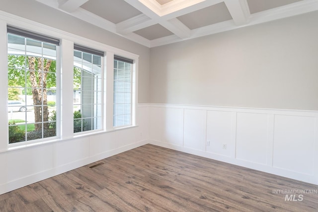 2527 E Taormina Dr, Meridian, ID 83642 - unfurnished room featuring healthy amount of natural light, beam ceiling, coffered ceiling, wood finished floors, and a decorative wall