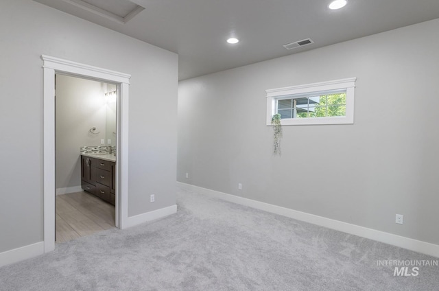 2527 E Taormina Dr, Meridian, ID 83642 - unfurnished bedroom with light colored carpet, recessed lighting, baseboards, ensuite bathroom, and attic access
