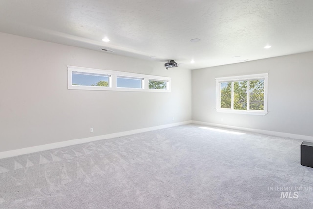 2527 E Taormina Dr, Meridian, ID 83642 - empty room with carpet floors, baseboards, recessed lighting, and a textured ceiling