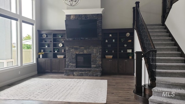 2527 E Taormina Dr, Meridian, ID 83642 - living area featuring stairway, wood finished floors, a stone fireplace, and a high ceiling