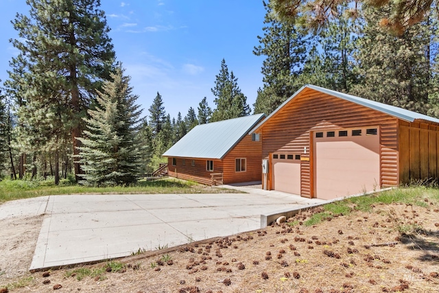 4 Pinon Way, Idaho City, ID 83631 - view of property exterior featuring a metal roof, a garage, and an outdoor structure