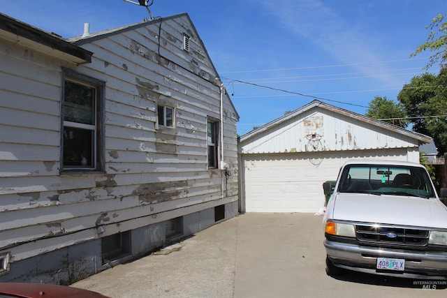 view of side of property featuring a garage and an outdoor structure