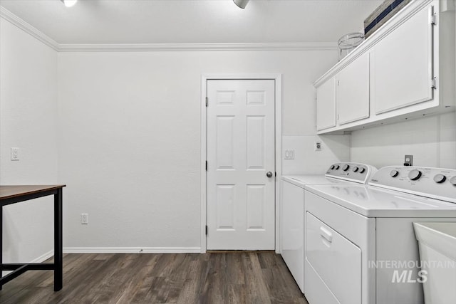 clothes washing area with cabinet space, dark wood-type flooring, independent washer and dryer, and ornamental molding